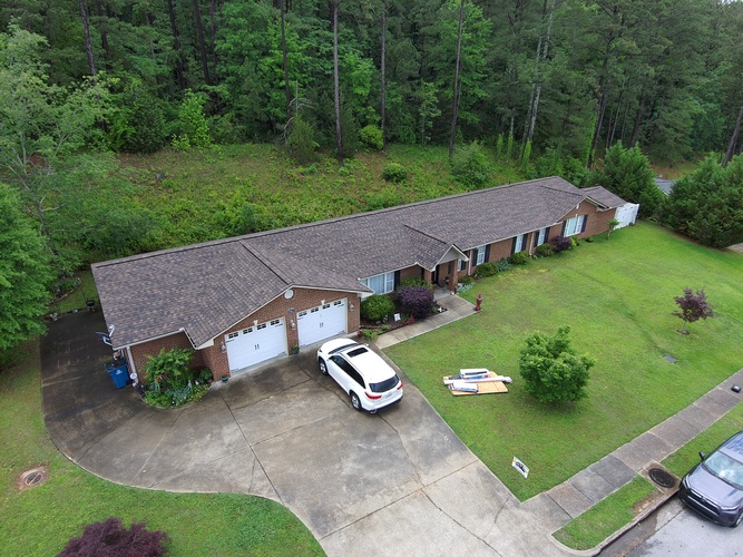 view from above of a home with a shingle roof